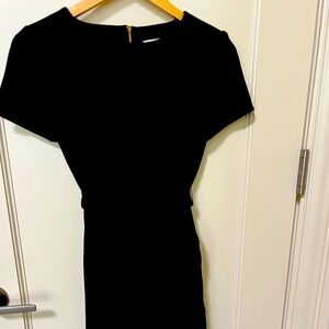 Calvin Klein Black Dress with Tie Waist and Ruffle Skirt.